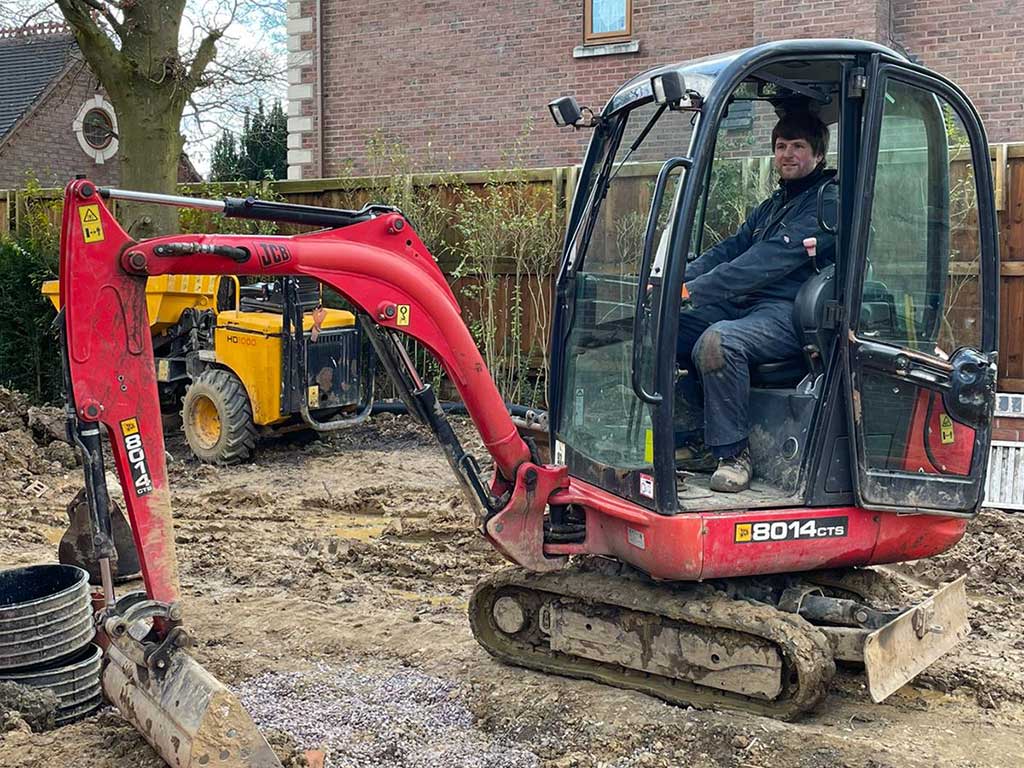 Penkhull Electrical owner Greg Smith in a digger preparing for outside electrics