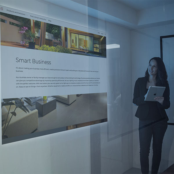 Woman standing in smart board room with automated with Control4