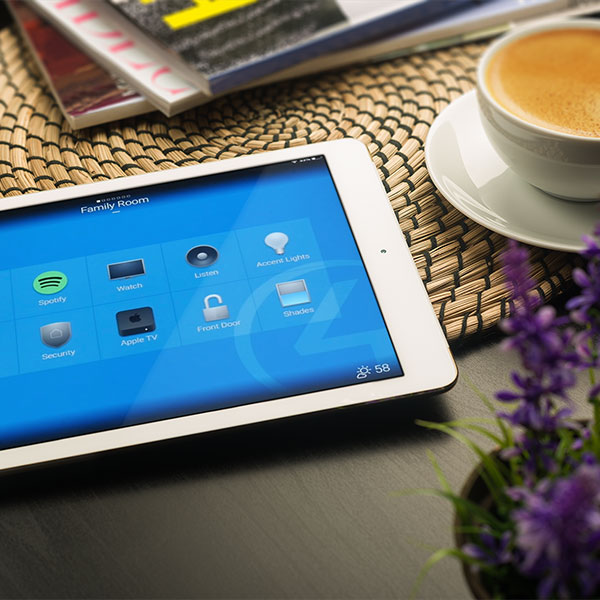 iPad sits on coffee table with an iPad open on the Control4 home automation app